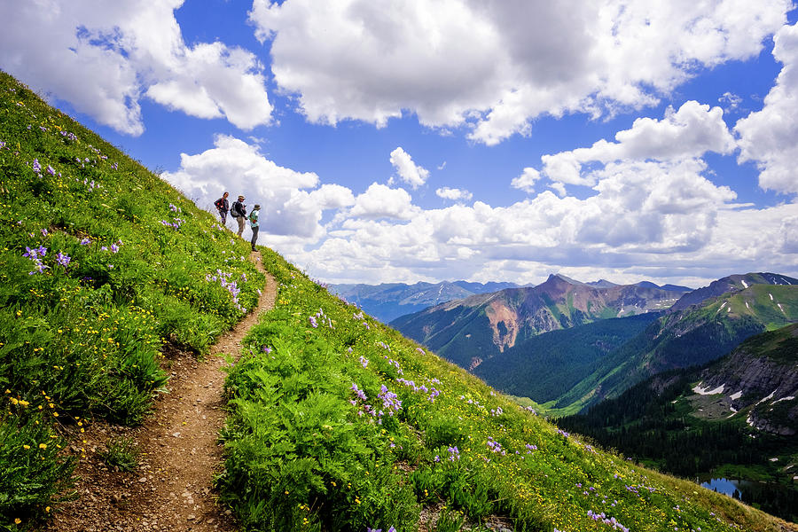 Hikers Looking At Valley In Mountains Photograph by Kyle Ledeboer