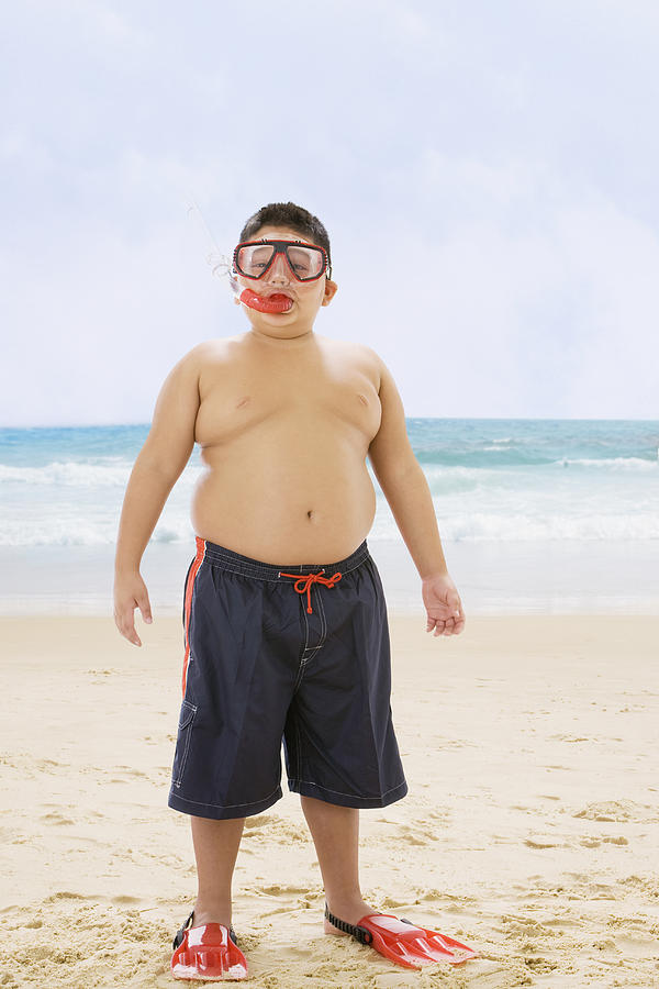 Hispanic boy standing at beach in snorkel gear Photograph by Jose Luis Pelaez Inc