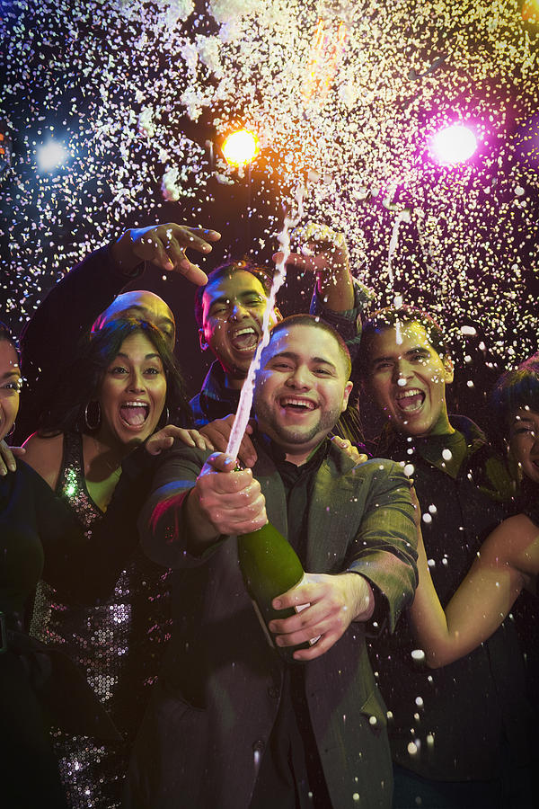 Hispanic friends drinking champagne in nightclub Photograph by Jose Luis Pelaez Inc