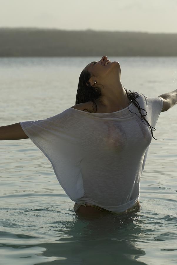 Hispanic woman wearing shirt in water Photograph by Laindiapiaroa