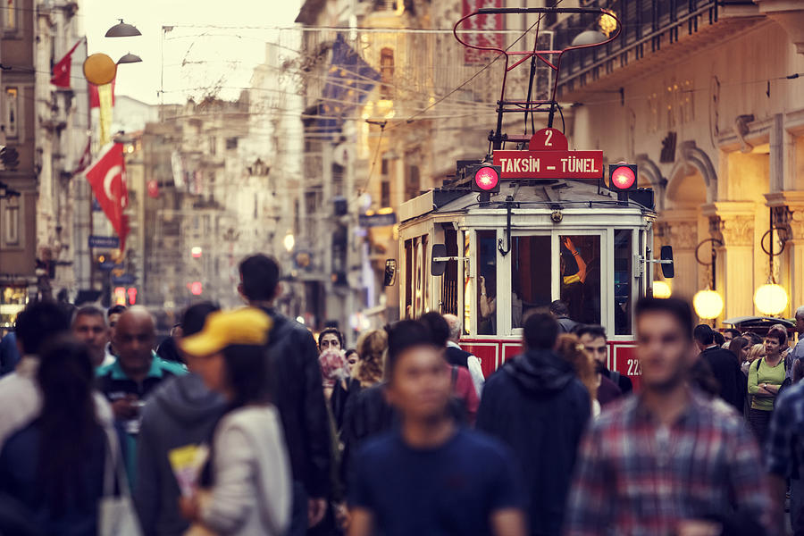 Historic red tram on crowded Istiklal Avenue in Taksim, Istanbul Photograph by Damircudic