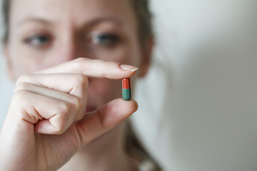 Holding a pill Photograph by Christoph Hetzmannseder