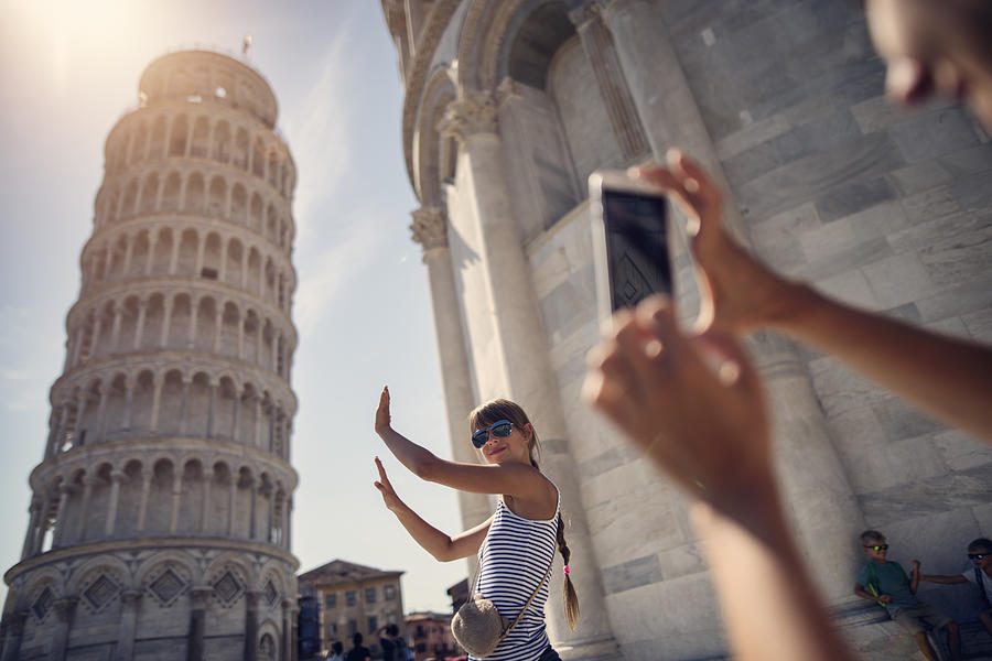 holding up photos of the Leaning Tower of Pisa Photograph by Imgorthand