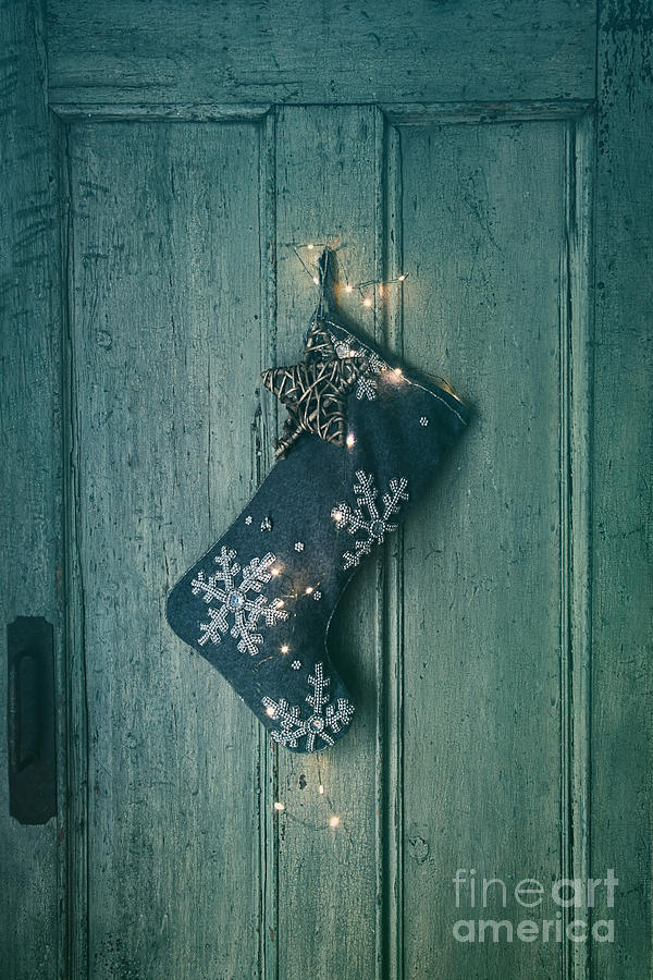 Christmas Photograph - Holiday stocking with lights hanging on old door by Sandra Cunningham
