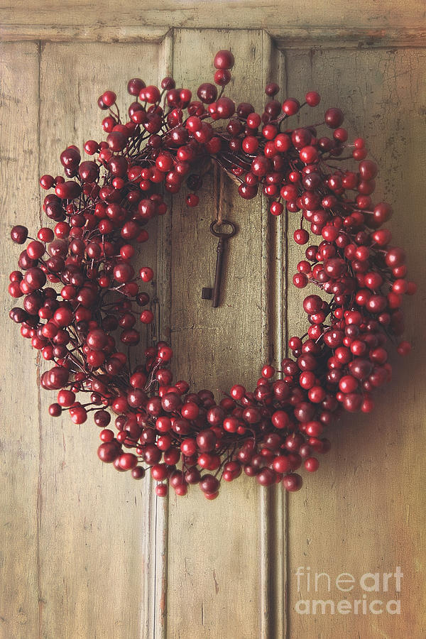 Holiday wreath hanging on old wood door Photograph by Sandra Cunningham