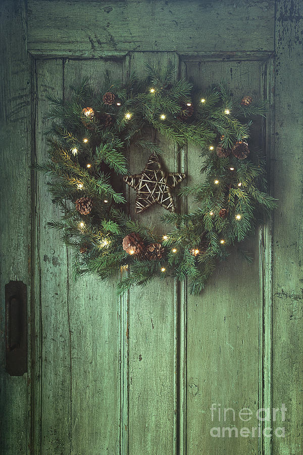 Holiday wreath on old wooden door Photograph by Sandra Cunningham