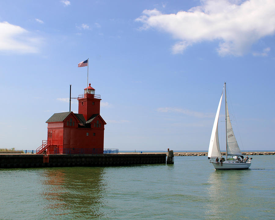 Lighthouse Photograph - Holland Harbor Lighthouse with Sailboat by George Jones
