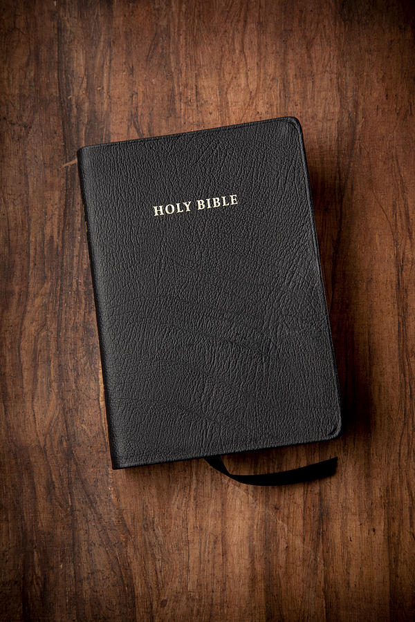 Holy Bible in Black Leather on Wood Background Photograph by Duckycards