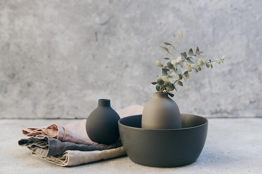 Home decor - neutral coloured vases and dish-ware and linen napkin in nordic style against grey wall. Photograph by Victoria Bee Photography
