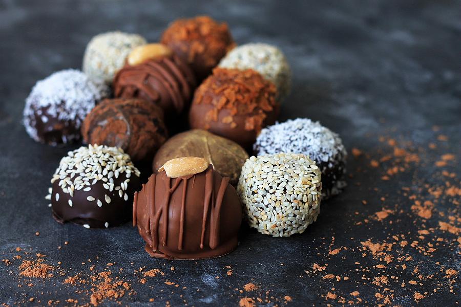 Homemade chocolate candies for Valentines Day on dark background. Photograph by Yulia Naumenko