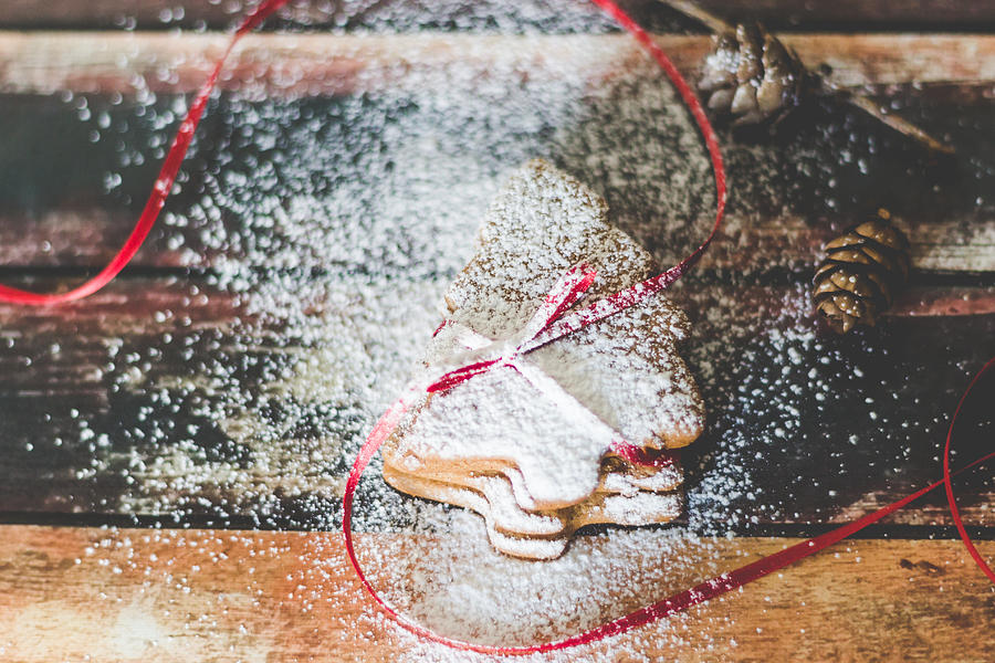 Christmas Photograph - Homemade Christmas cookies sprinkled with powdered sugar by Aldona Pivoriene