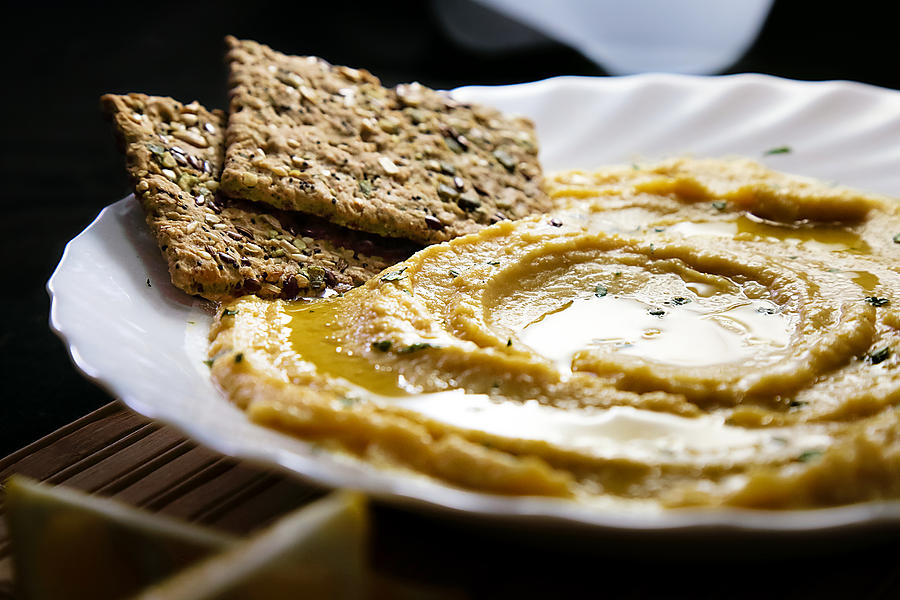 Homemade hummus with lemon, herbs, virgin olive oil and integral flatbread Photograph by DejanKolar