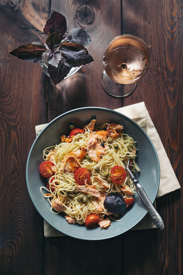 Homemade spaghetti pasta with salmon, tomatoes and capers Photograph by Alexandra Iakovleva
