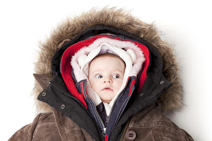 Hooded baby. Little girl in many winter jackets. Photograph by ThomasVogel