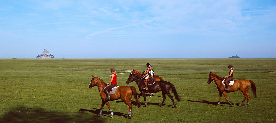 Horse Photograph - Horseback Riders In A Field With Mont by Panoramic Images
