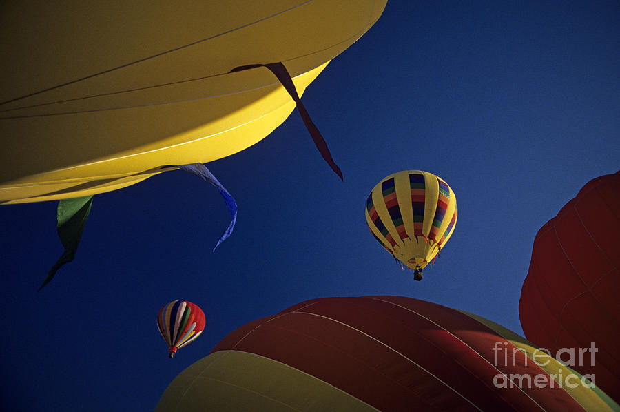 Hot air ballons lifting off Photograph by Jim Corwin