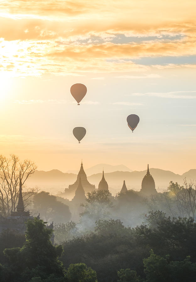 Hot air balloon over pagodas Photograph by © Razvan Ciuca