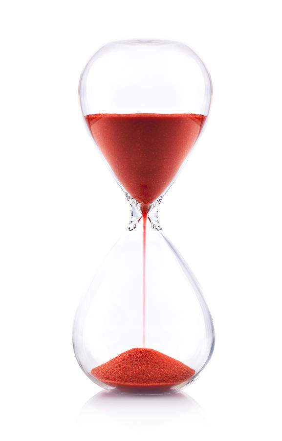 Hourglass with red sand on white background - Time concept Photograph by Deepblue4you
