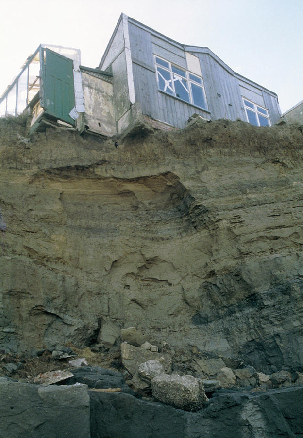 House Located At The Edge Of A Sea Eroded Cliff Photograph by Graeme Ewens/science Photo Library