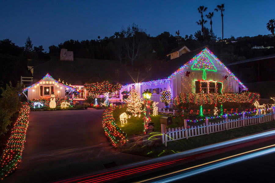 House with abundant exterior Christmas lights Photograph by Rob Lewine