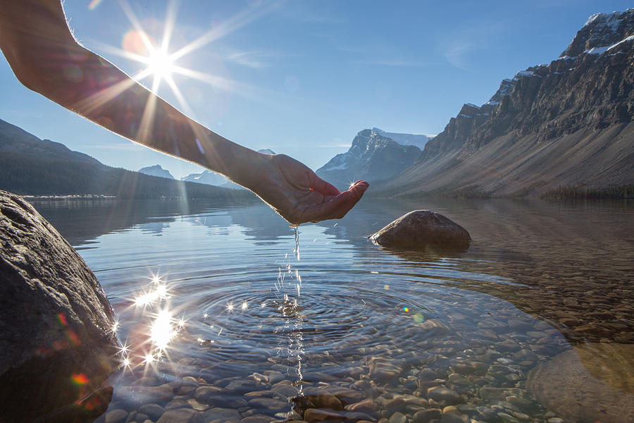Human hand cupped to catch the fresh water from lake Photograph by Swissmediavision