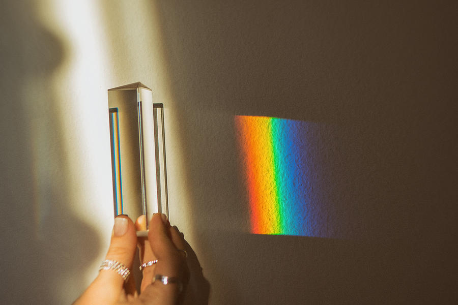 Human hand holding optical prism while making rainbow reflection Photograph by Emilija Manevska