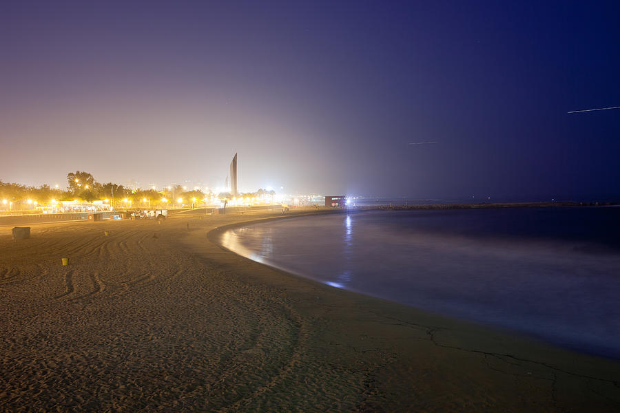 Icaria Beach in Barcelona at Night Photograph by Artur Bogacki