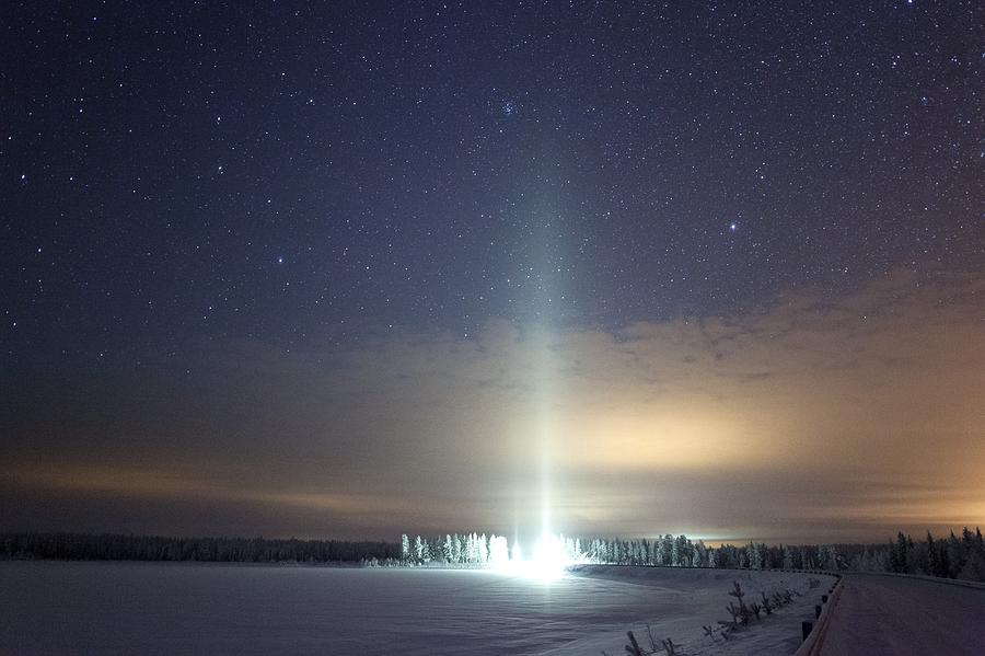 Winter Photograph - Ice pillar in night sky by Science Photo Library