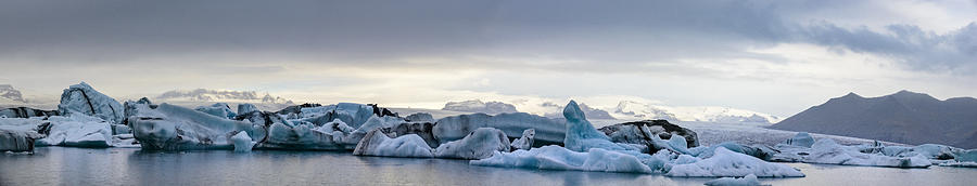 Icebergs floating  in the Jokulsalon glacier lagoon in Iceland Photograph by Sjo