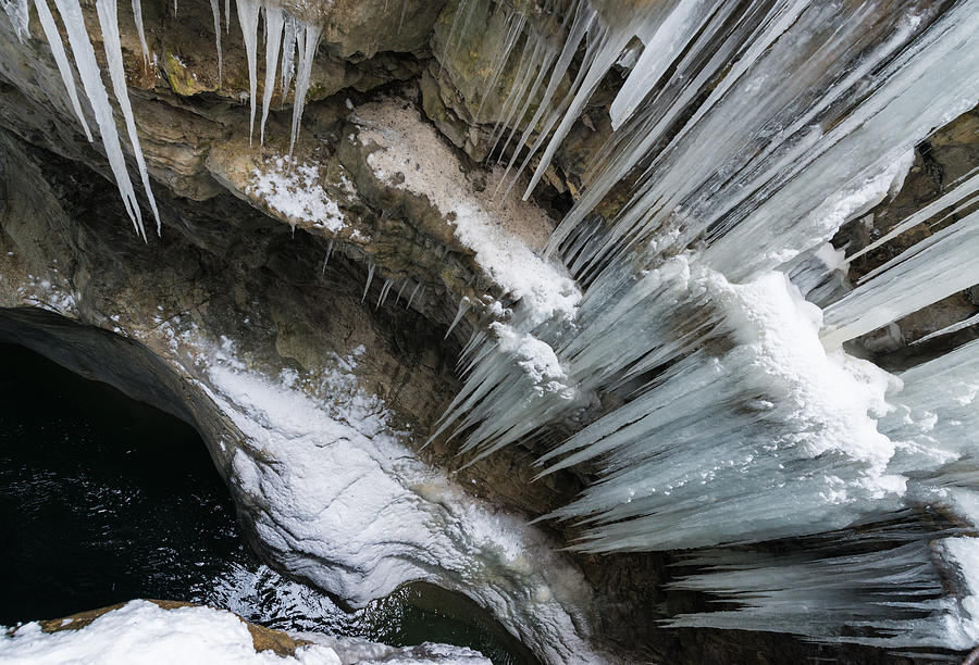 Icicles hanging in rocky gorge in cold winter Photograph by Matthias Hauser