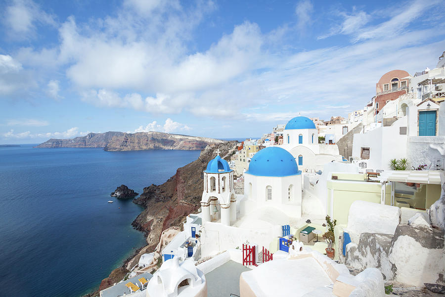 Iconic Blue Domed Churches In Oia Photograph by Matteo Colombo