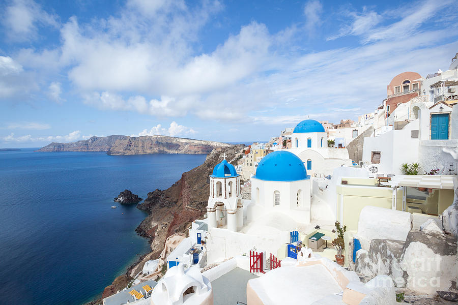 Iconic blue domed churches in Oia Santorini Greece Photograph by Matteo Colombo