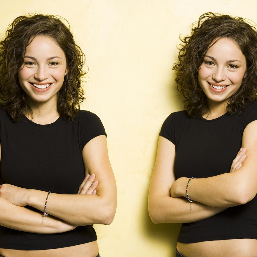 Identical twin teenage girls Photograph by Rubberball