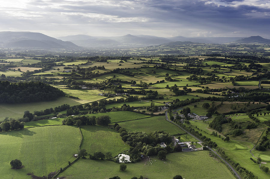 Idyllic country meadows misty mountains aerial landscape Photograph by fotoVoyager