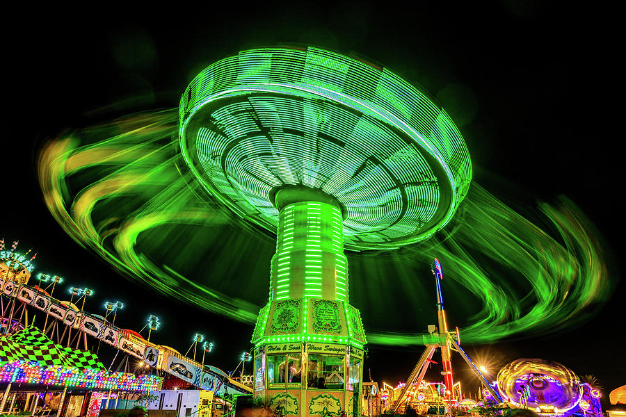 Illuminated Fair Ride With Blurred Neon Photograph By Panoramic Images ...