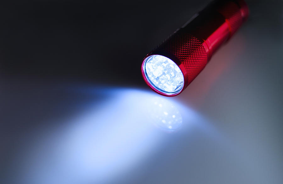 Illuminated flashlight Photograph by Tetra Images