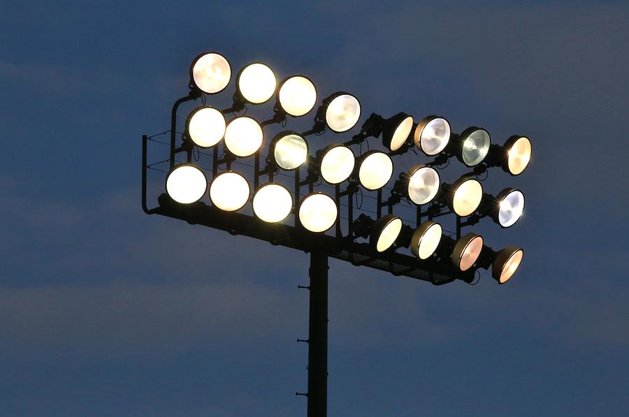 Illuminated overhead stadium scene lights Photograph by Douglas Sacha