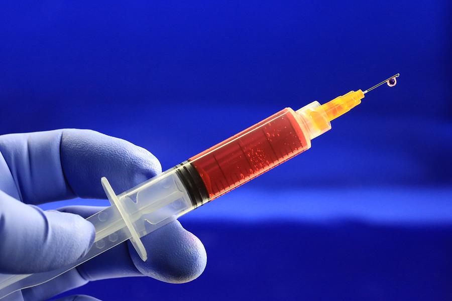 Image of syringe with hypodermic needle, close-up Photograph by Douglas Sacha