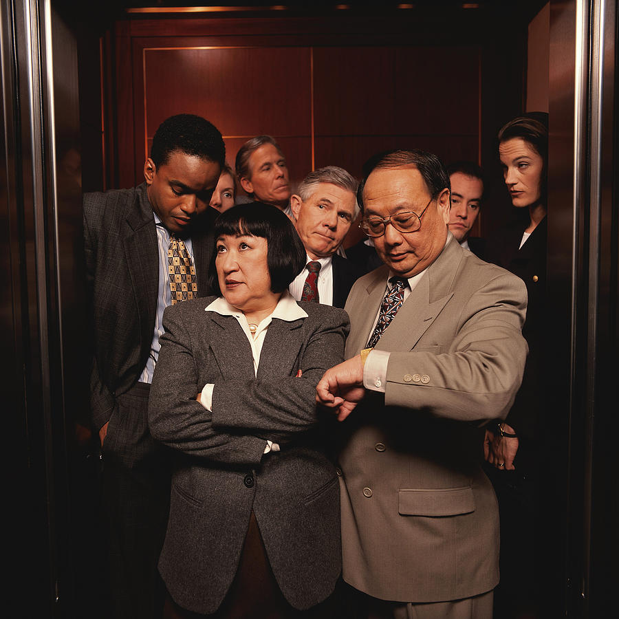 Impatient Businesspeople in a Crowded Elevator Photograph by Keith Brofsky