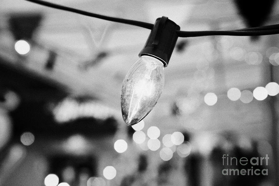 Christmas Photograph - incandescent decorative bulb lighting at a venue in Vancouver BC Canada by Joe Fox