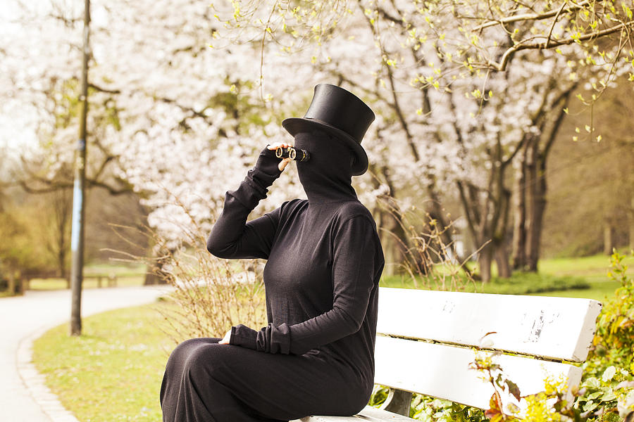 Incognito woman in black dress using binoculars Photograph by Yulia Reznikov