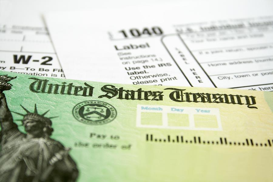 Income tax refund check on tax forms Photograph by Agshotime