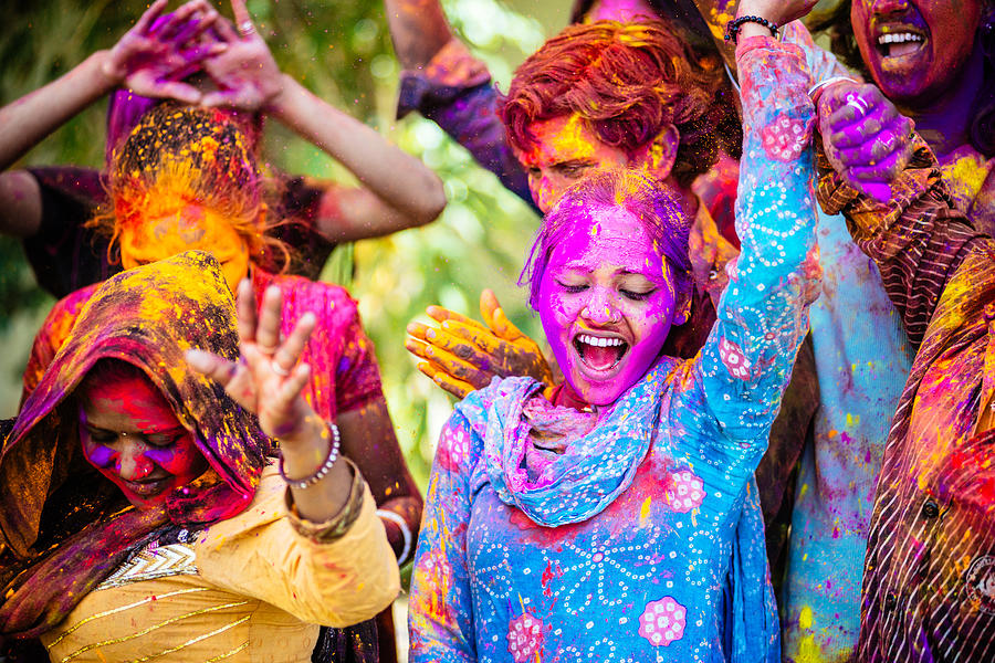 Indian Friends Dancing Covered on Holi colorful powder in India Photograph by Ferrantraite