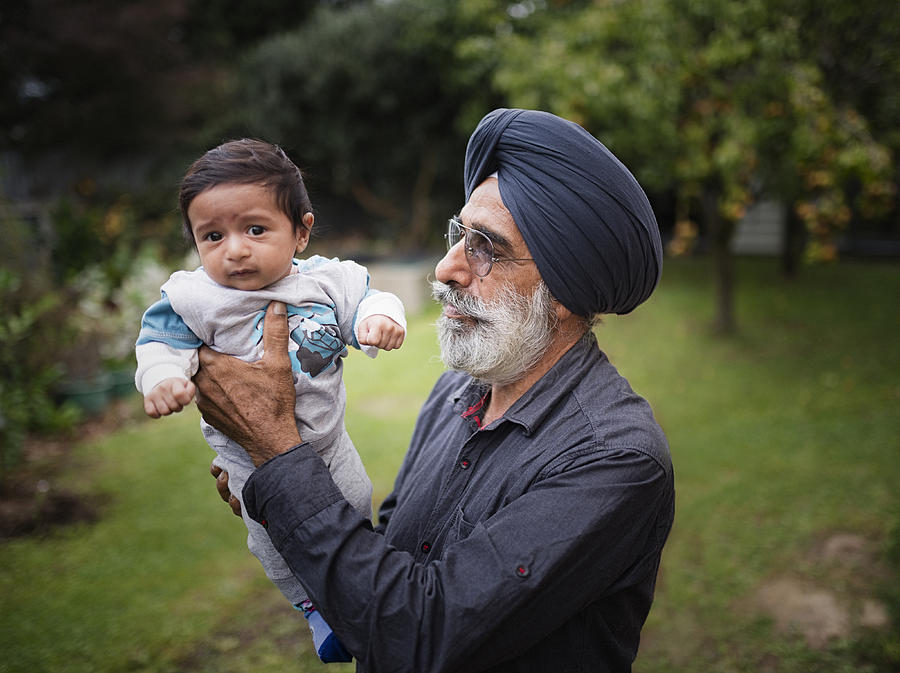 Indian grandfather holding baby grandson Photograph by Donald Iain Smith