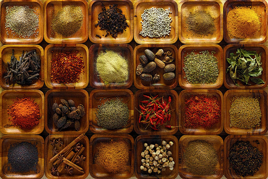 Indian spices in wooden trays. Photograph by Enviromantic