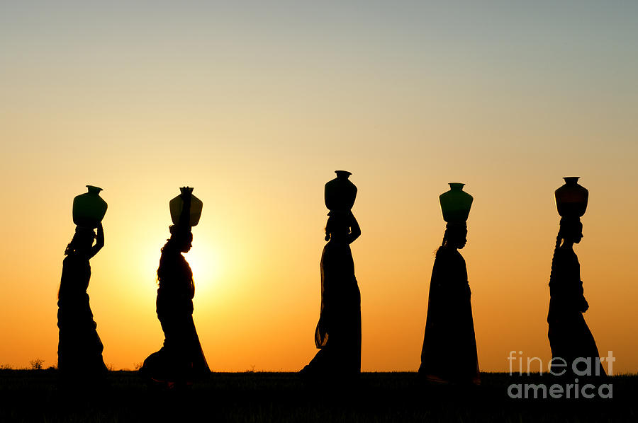 Indian Women Carrying Water Pots At Sunset Photograph by Tim Gainey