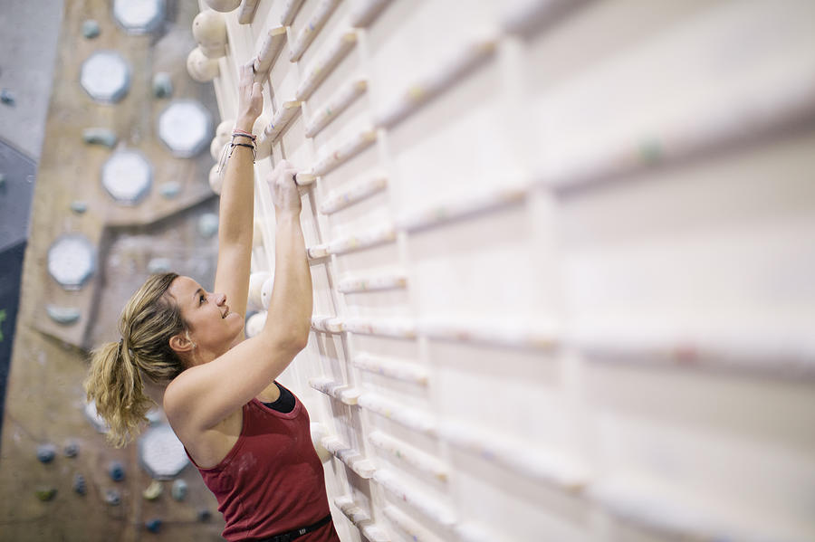 Indoor climbing in the bouldering gym wall. Photograph by Tempura