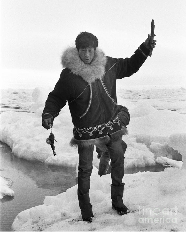 Ice Fishing Photograph - Inuit boy Ice Fishing using a niksik  Barrow Alaska July 1969 by Monterey County Historical Society