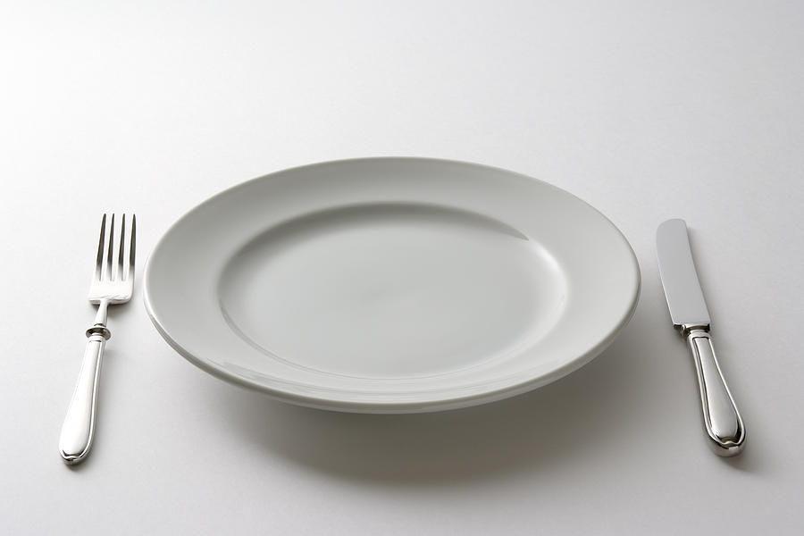 Isolated shot of empty plate and cutlery on white background Photograph by Kyoshino