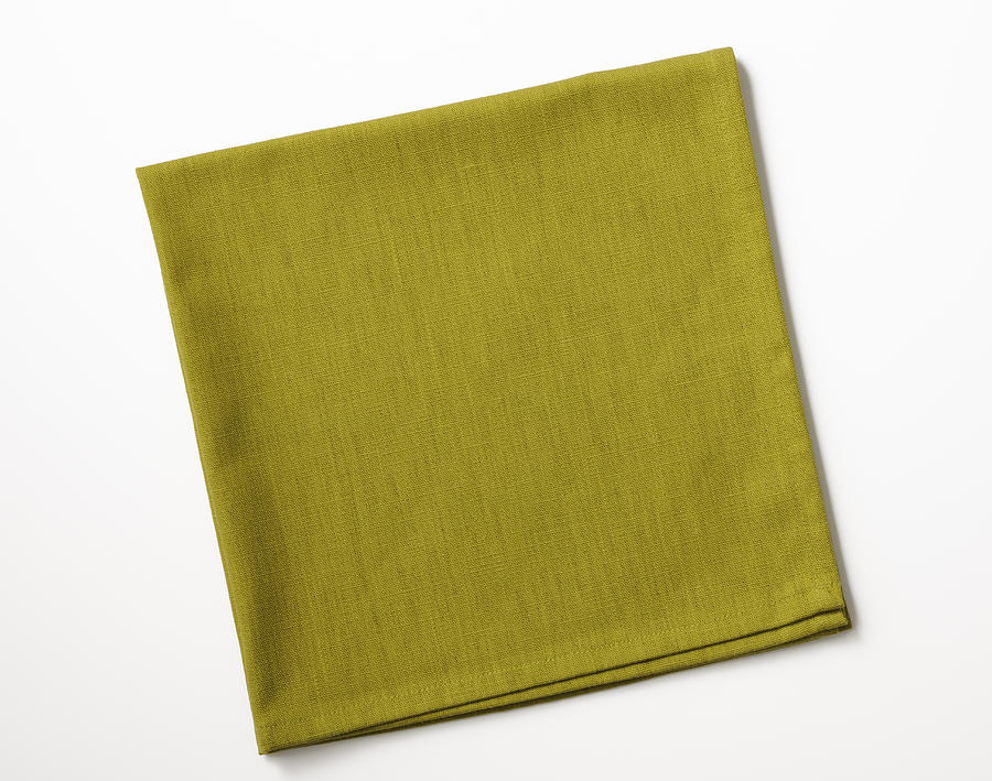 Isolated shot of folded green napkin on white background Photograph by Kyoshino